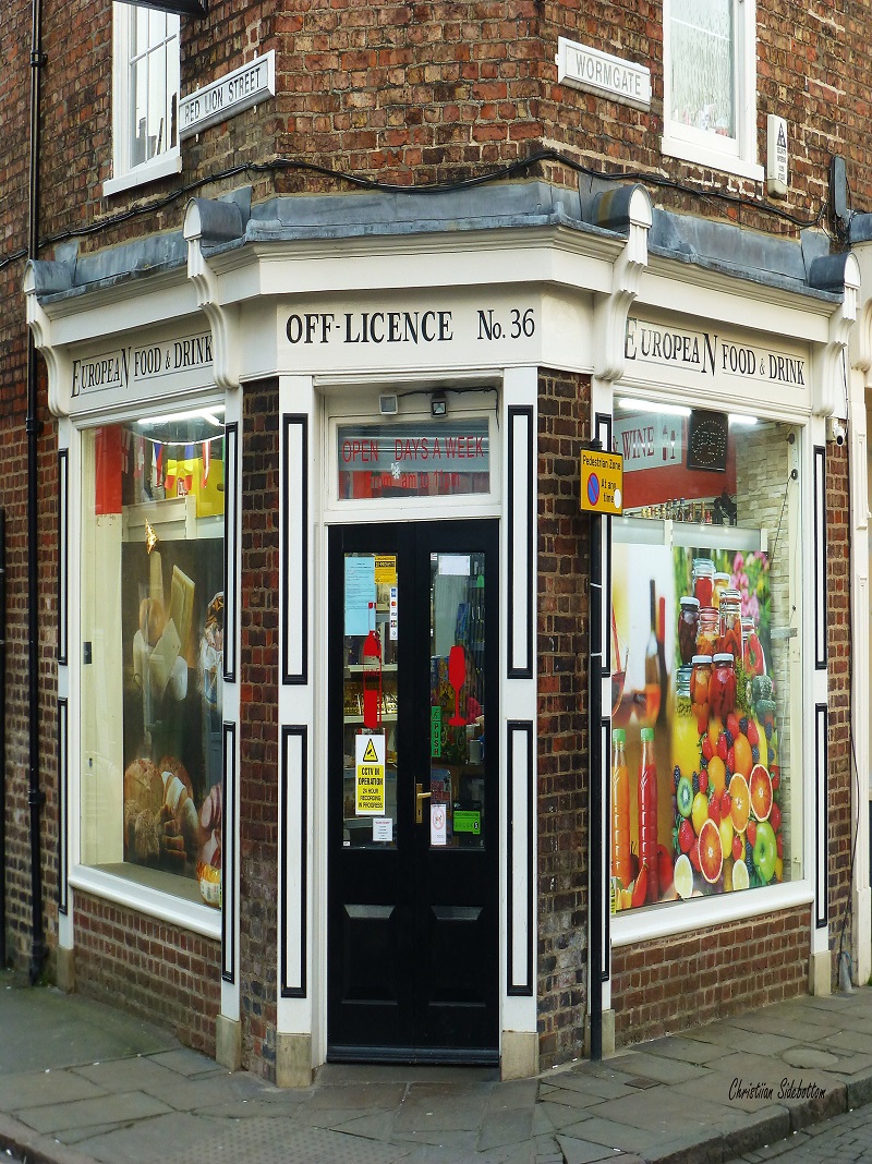 A photograph of a corner shop at number 36, that is currently run as a European corner shop and off-licence.